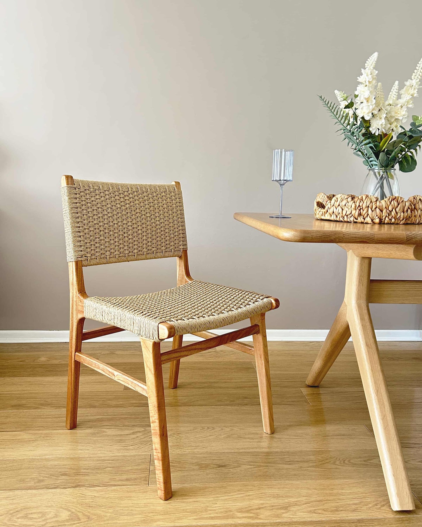 Dining room featuring Asturia wooden dining chairs with woven seats in natural peanut mind wood | Mellowdays Furniture