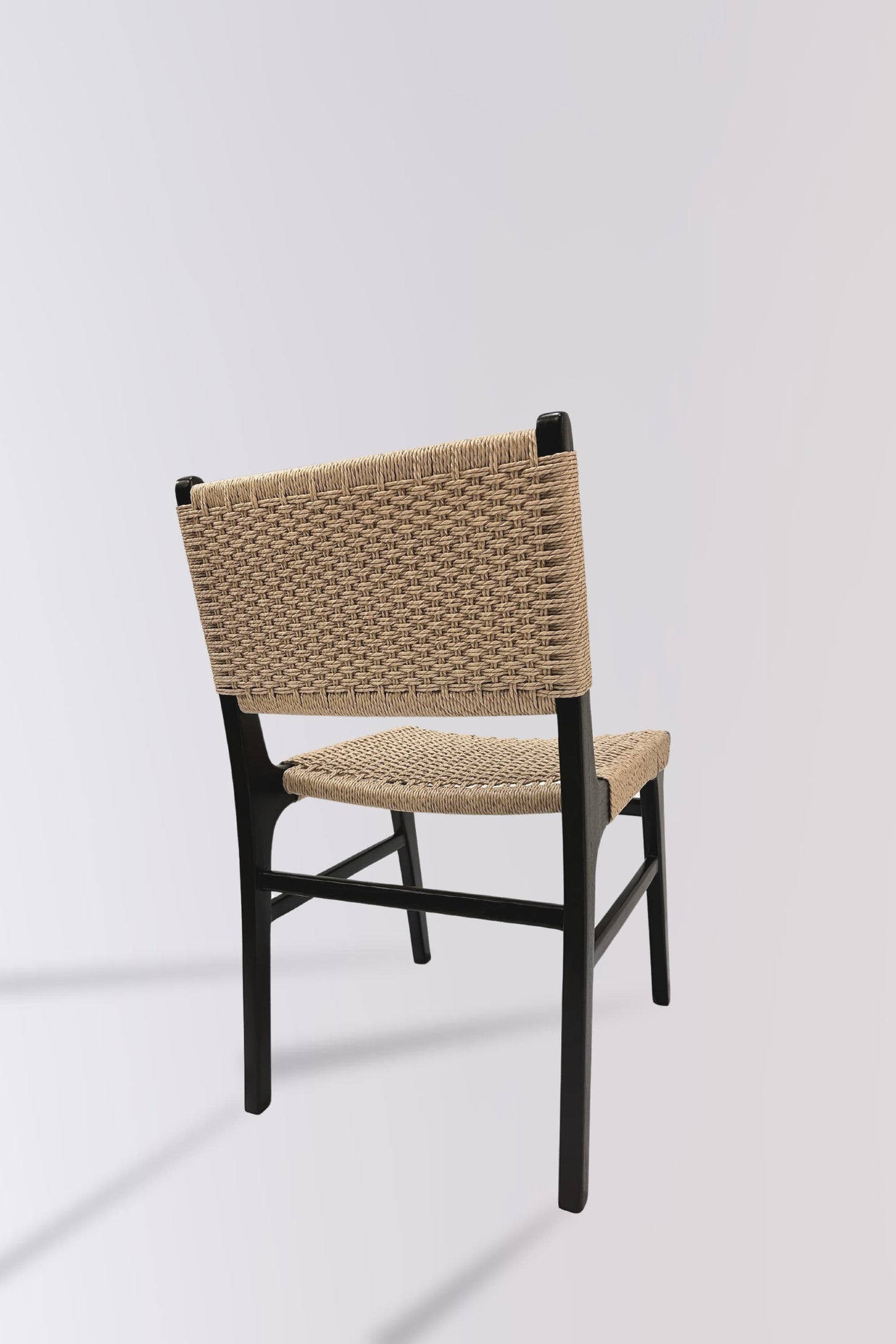 Back of Asturia woven wooden dining chair in mindi wood with black fininsh showing detailed handwoven water hyacinth design | Mellowdays Furniture