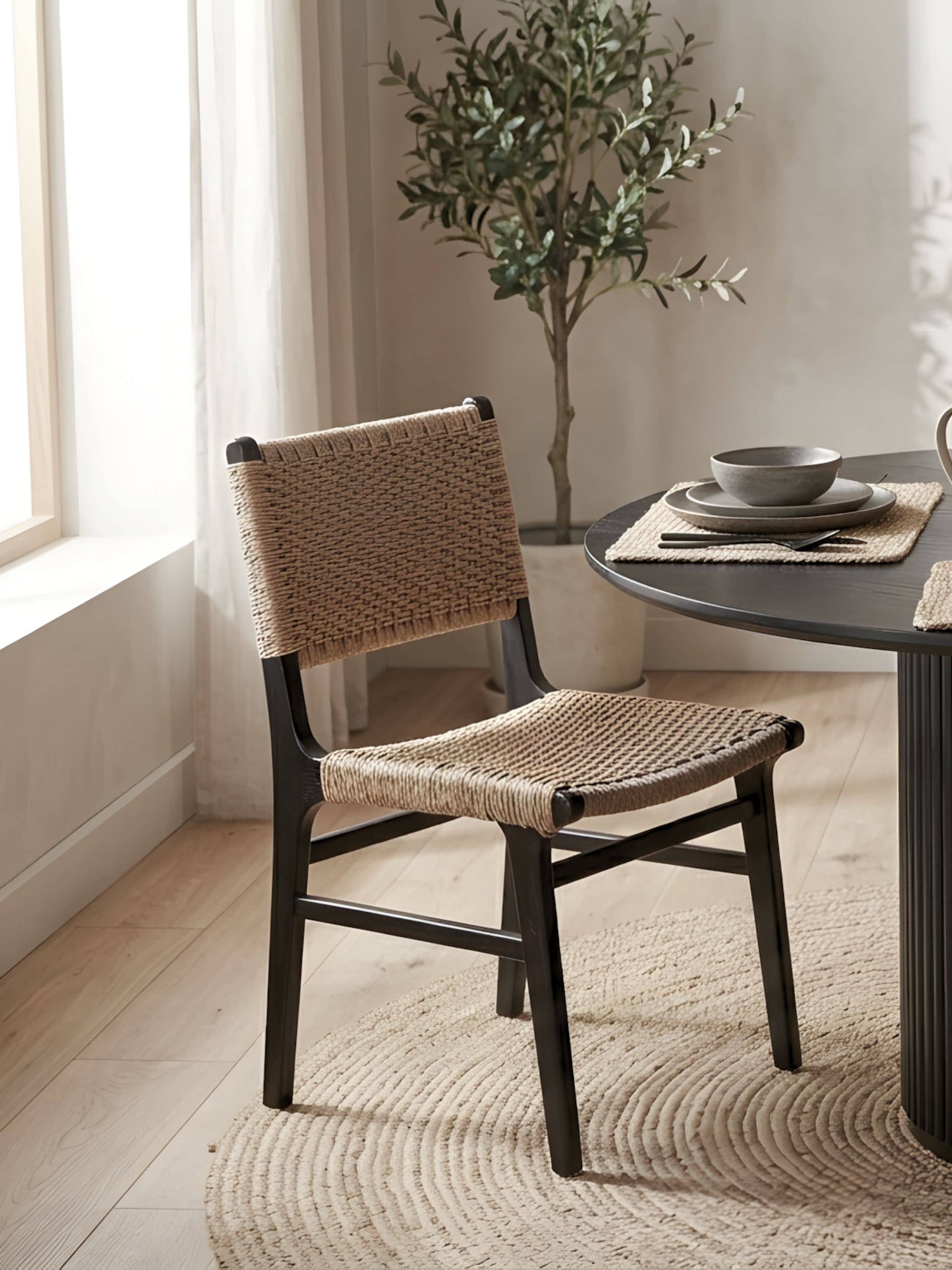 Dining room corner with Asturia black wooden dining chair with handwoven seat and back