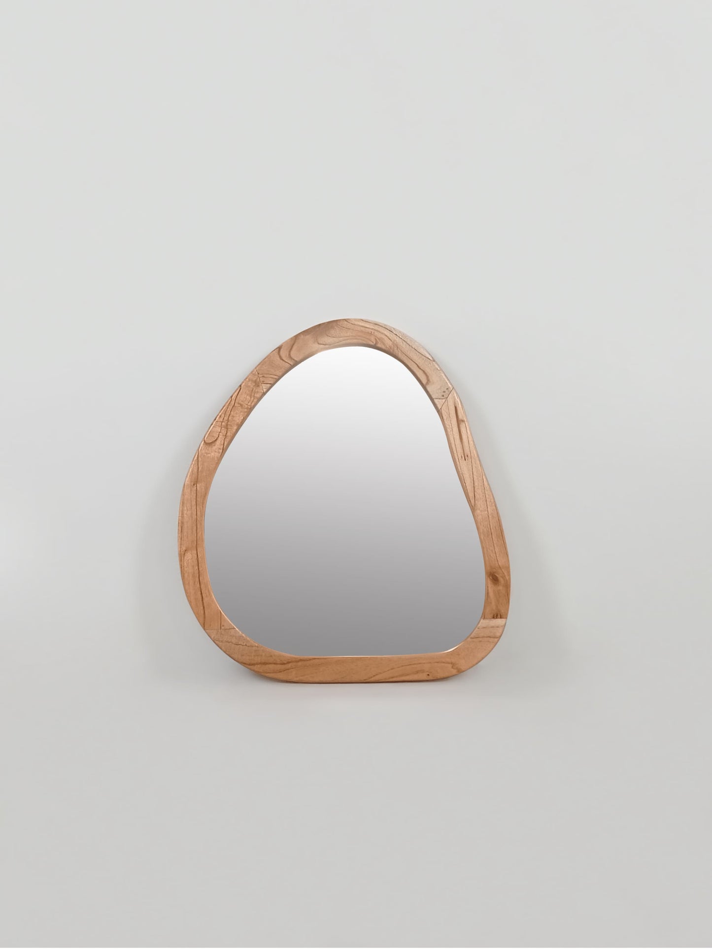 Organic shaped wooden wall mirror with pebble silhouette and natural wood frame in portrait orientation| Mellowdays Furniture