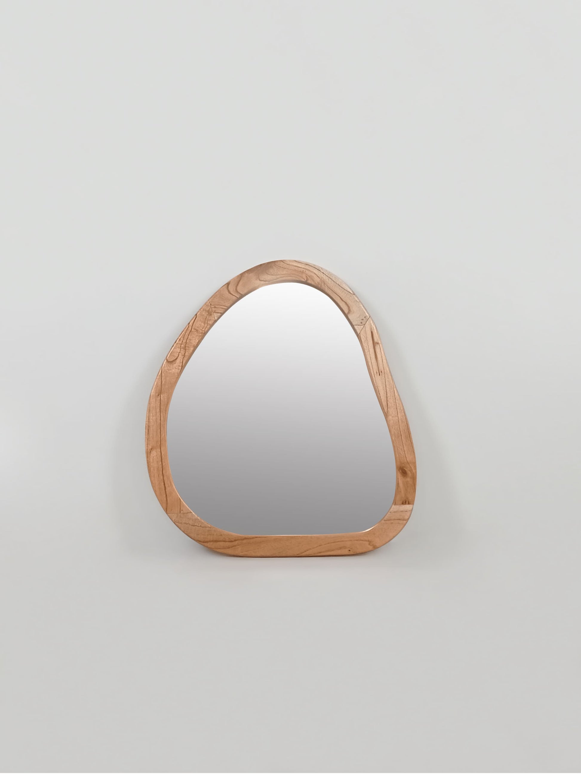 Organic shaped wooden wall mirror with pebble silhouette and natural wood frame in portrait orientation| Mellowdays Furniture