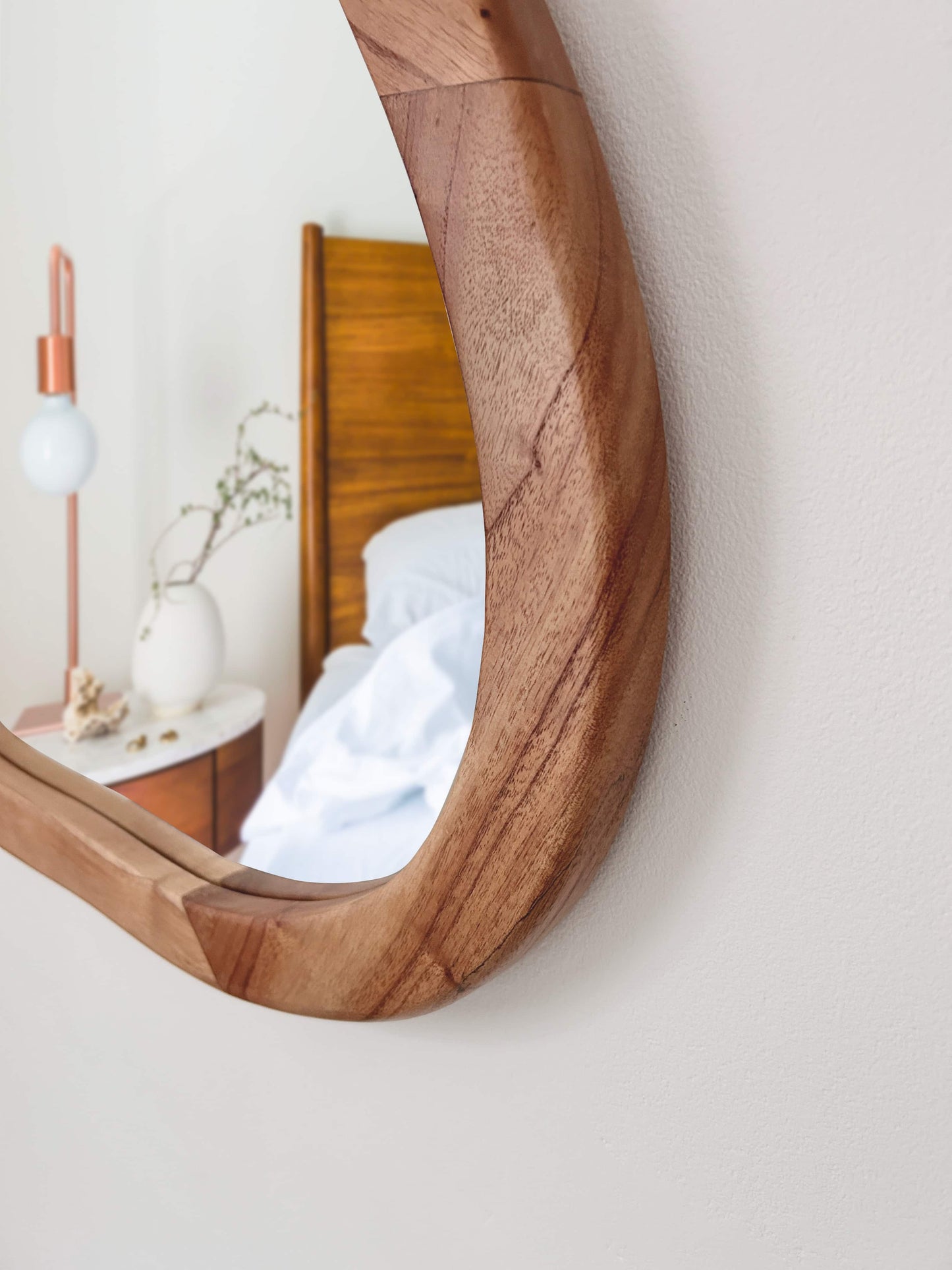 Close-up of curved organic wood mirror with smooth natural grain finish | Mellowdays Furniture