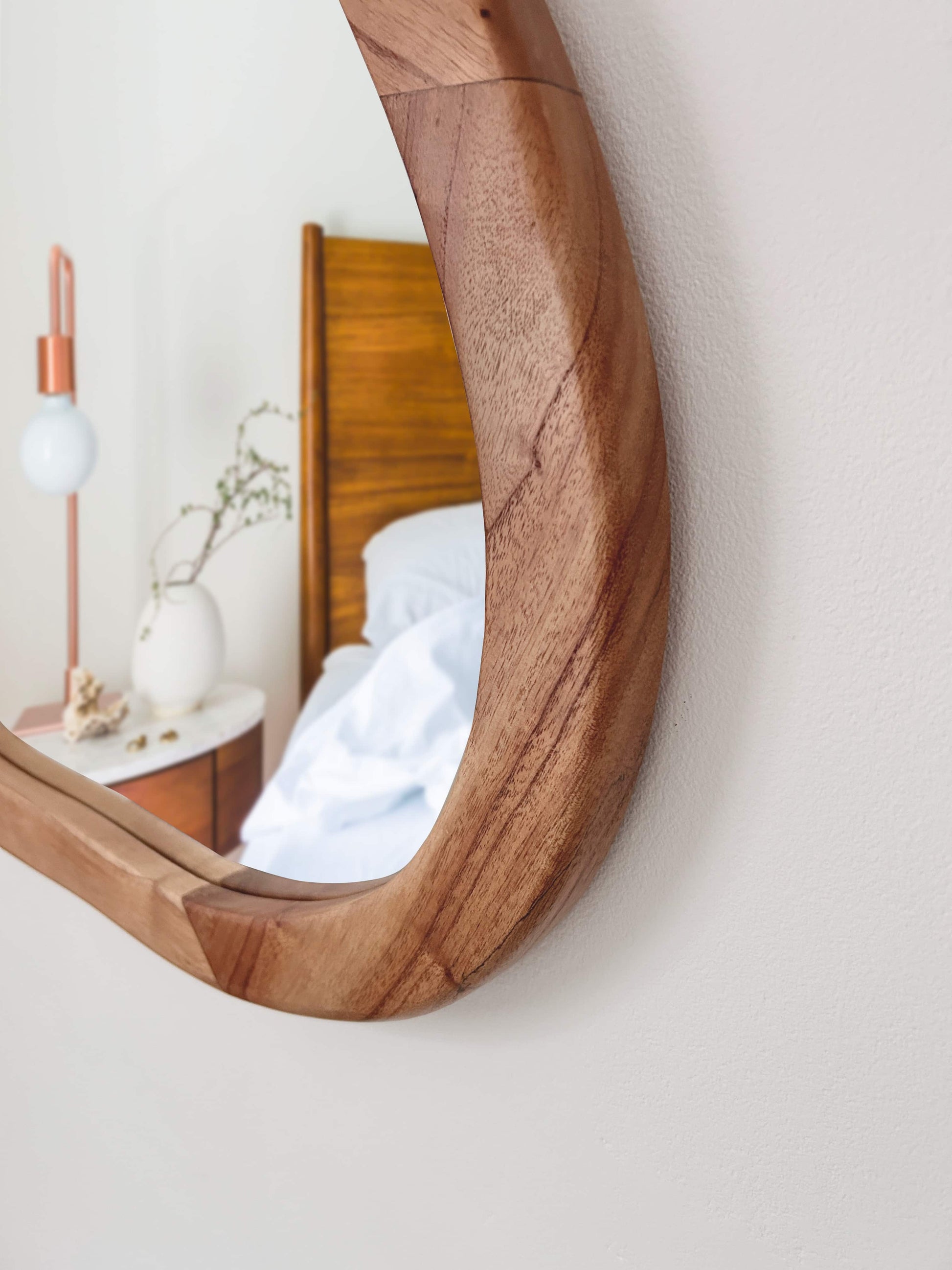 Close-up of curved organic wood mirror with smooth natural grain finish | Mellowdays Furniture