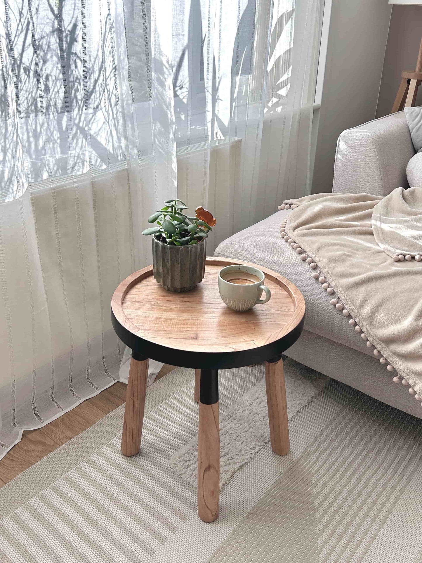 Tomasa Teakwood Round Tray Side Table in living room - Natural Teakwood with Black Accent Finish - Mellowdays Furniture